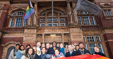 Residents celebrate as they fly the rainbow flag for LGBT+ History month.
