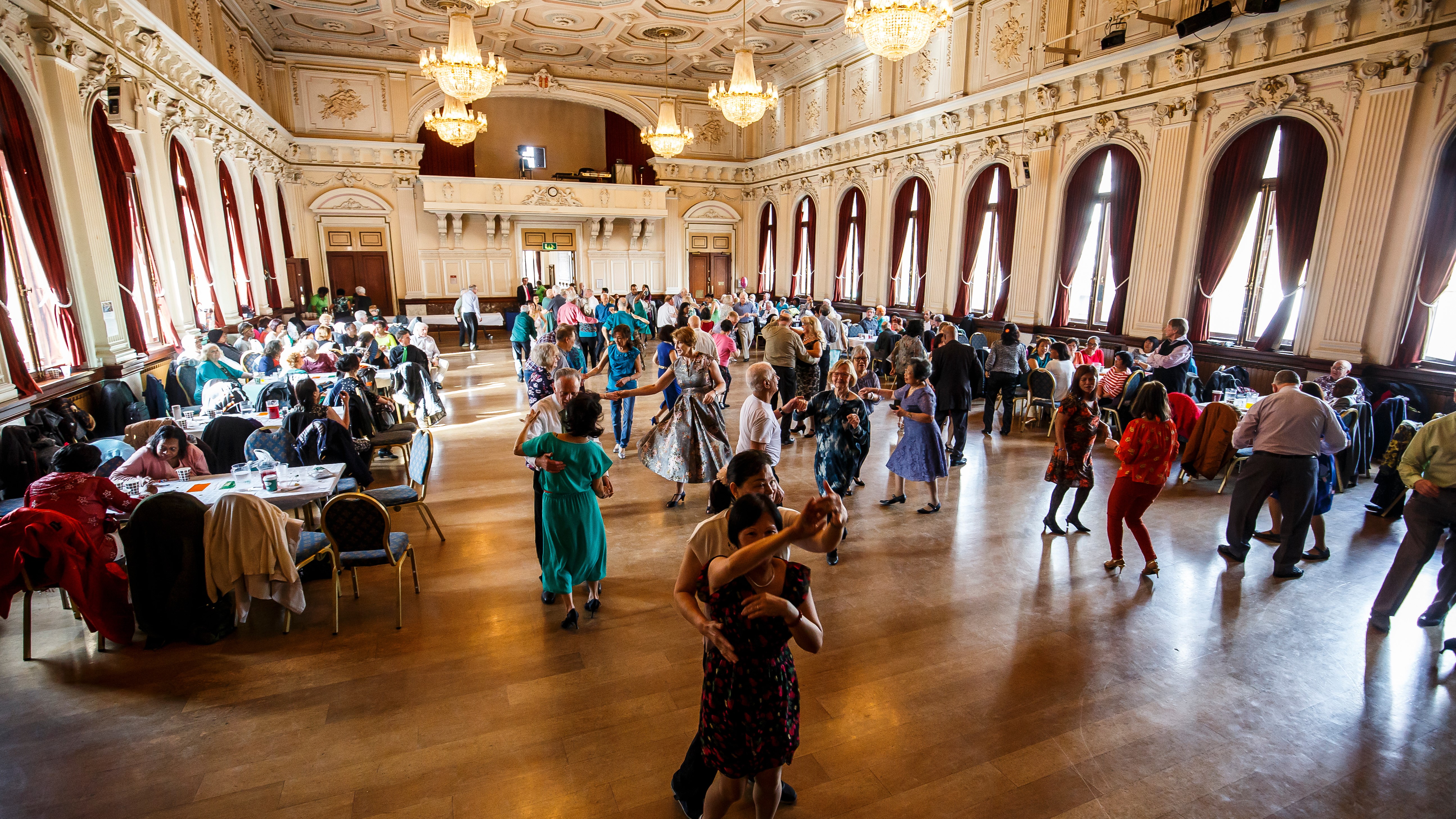 Couples enjoy a tea dance at the town hall