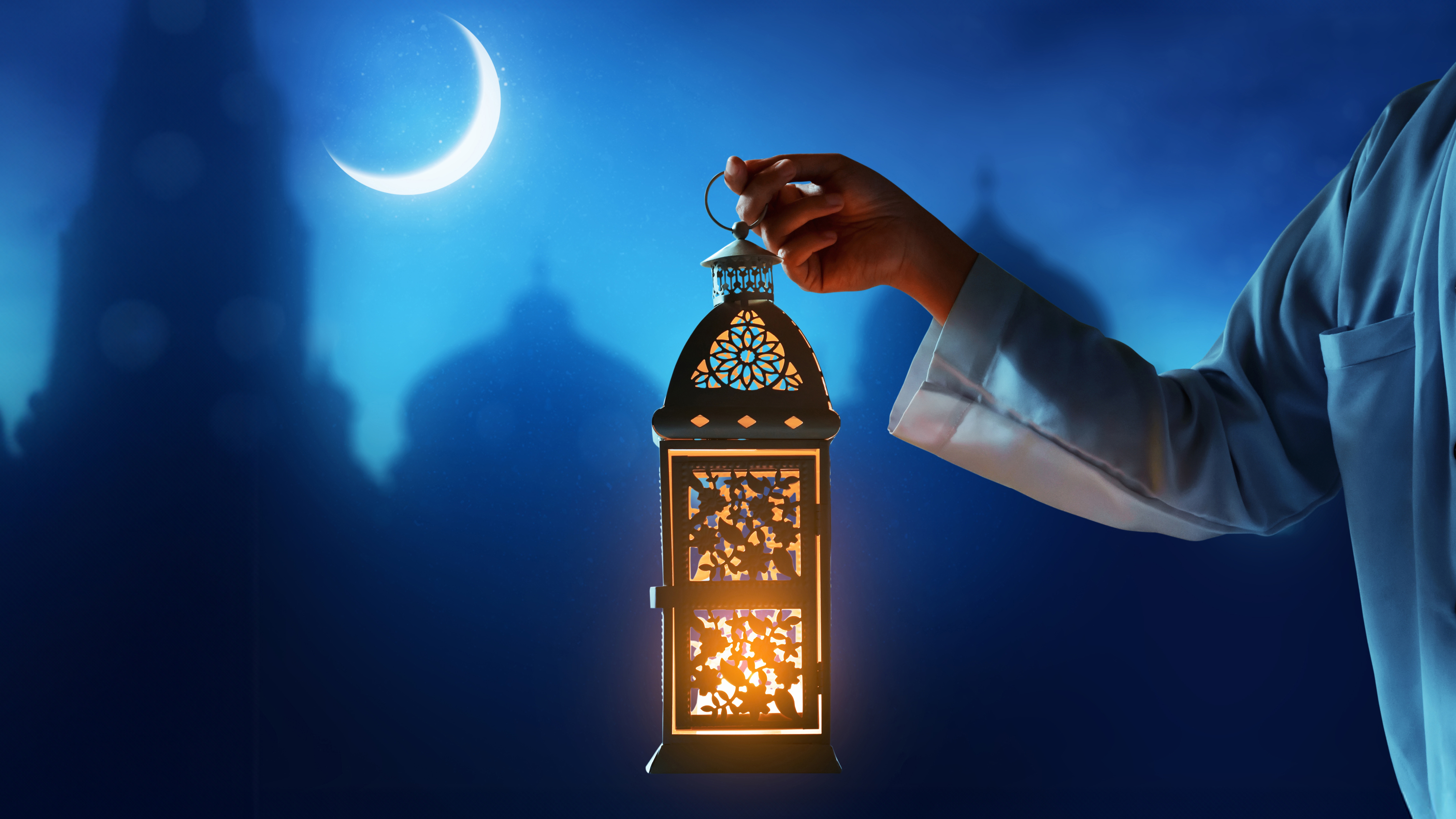 An image of someone holding a lantern to represent Ramadan