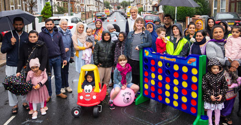 Residents on the road, with a big domino game