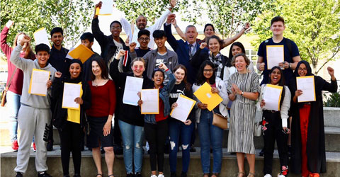 Children cheer as they receive their GCSE results.