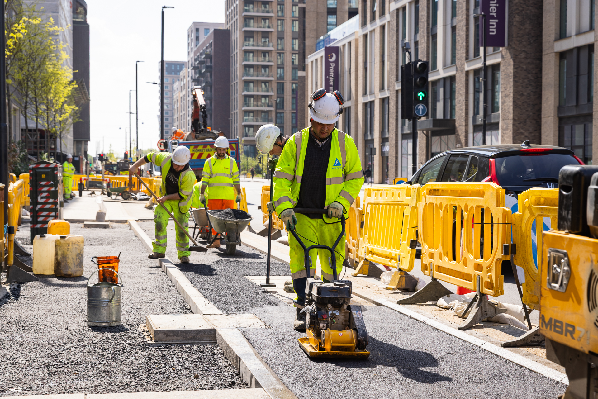 Contractors building a new cycle track upgrading the pavement in Canning Town as part of the Royal Docks Corridor project (May 2025)