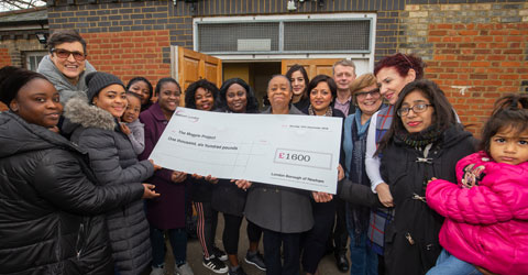 Residents and the Mayor of Newham standing with the &pound;1600 cheque for the Magpie Project.