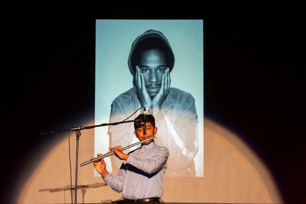 Boy playing flute on stage