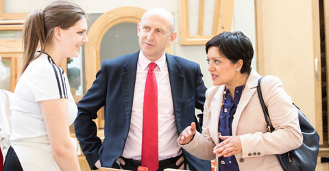 Rokshana Fiaz, John Healy and a resident at Building Craft College