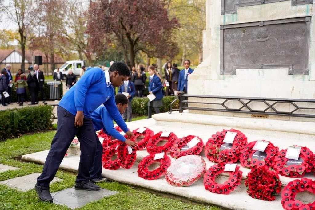 School boy laying down poppy