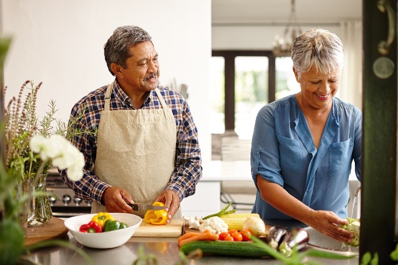 man and woman prepping healthy food