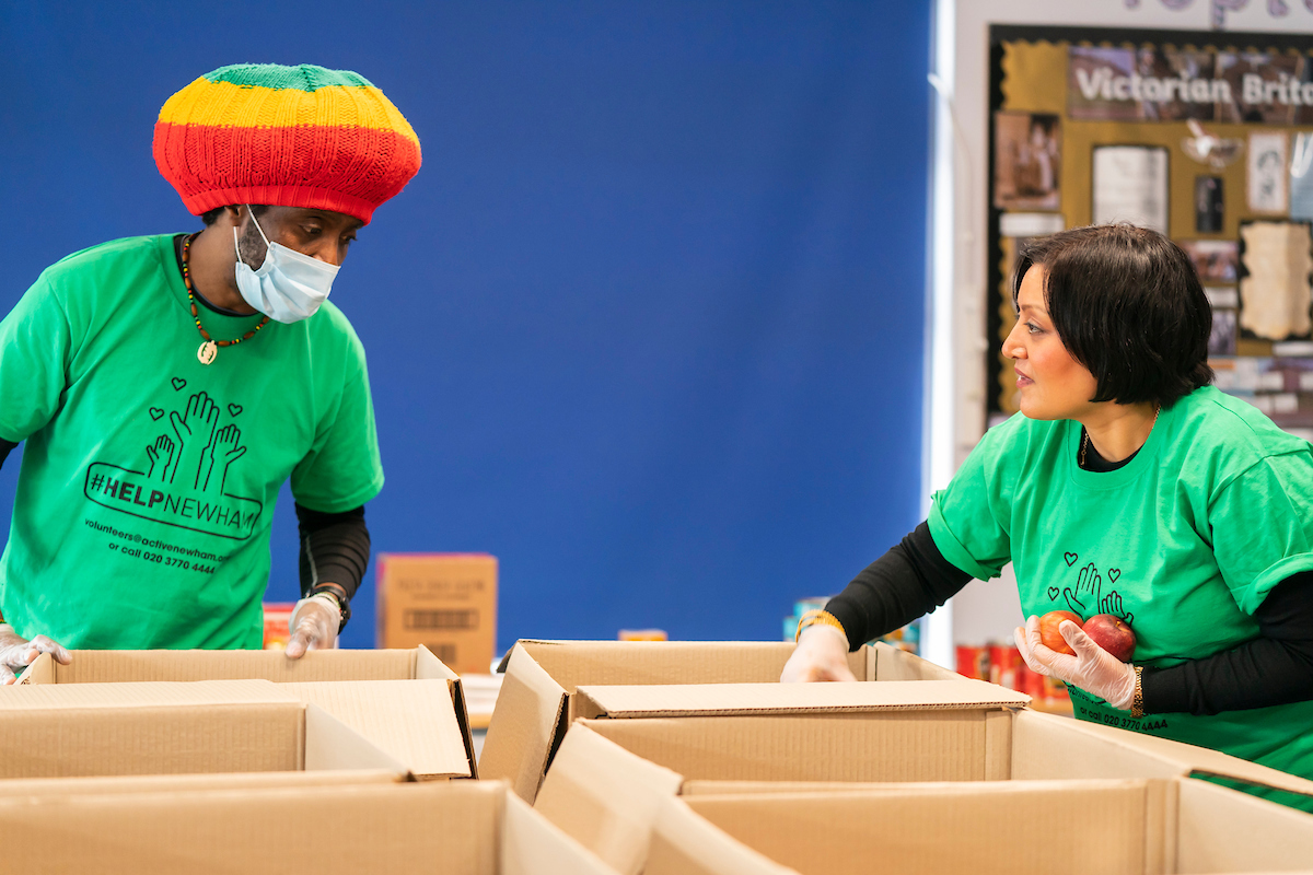 Mayor of Newham helps to pack food boxes to distribute to families in need